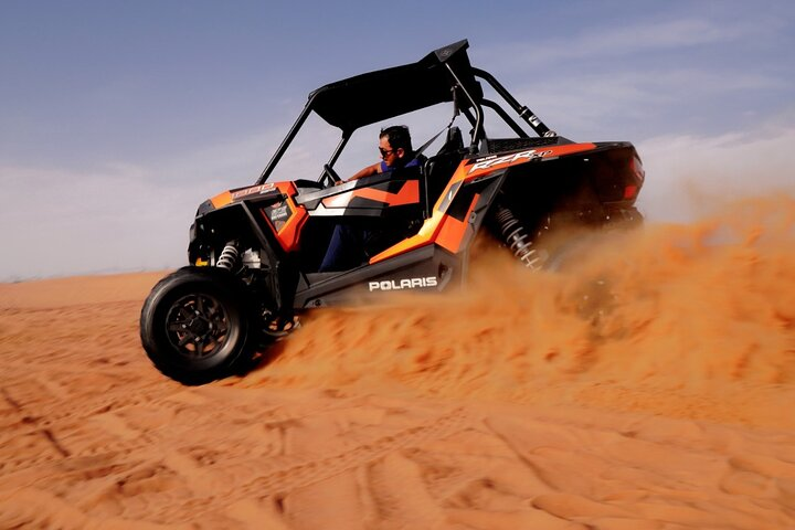 Experience the rush of driving a powerful buggy over stunning red dunes with expert guidance and breathtaking views of the desert landscape. Adventure awaits in Dubai's wild terrain!